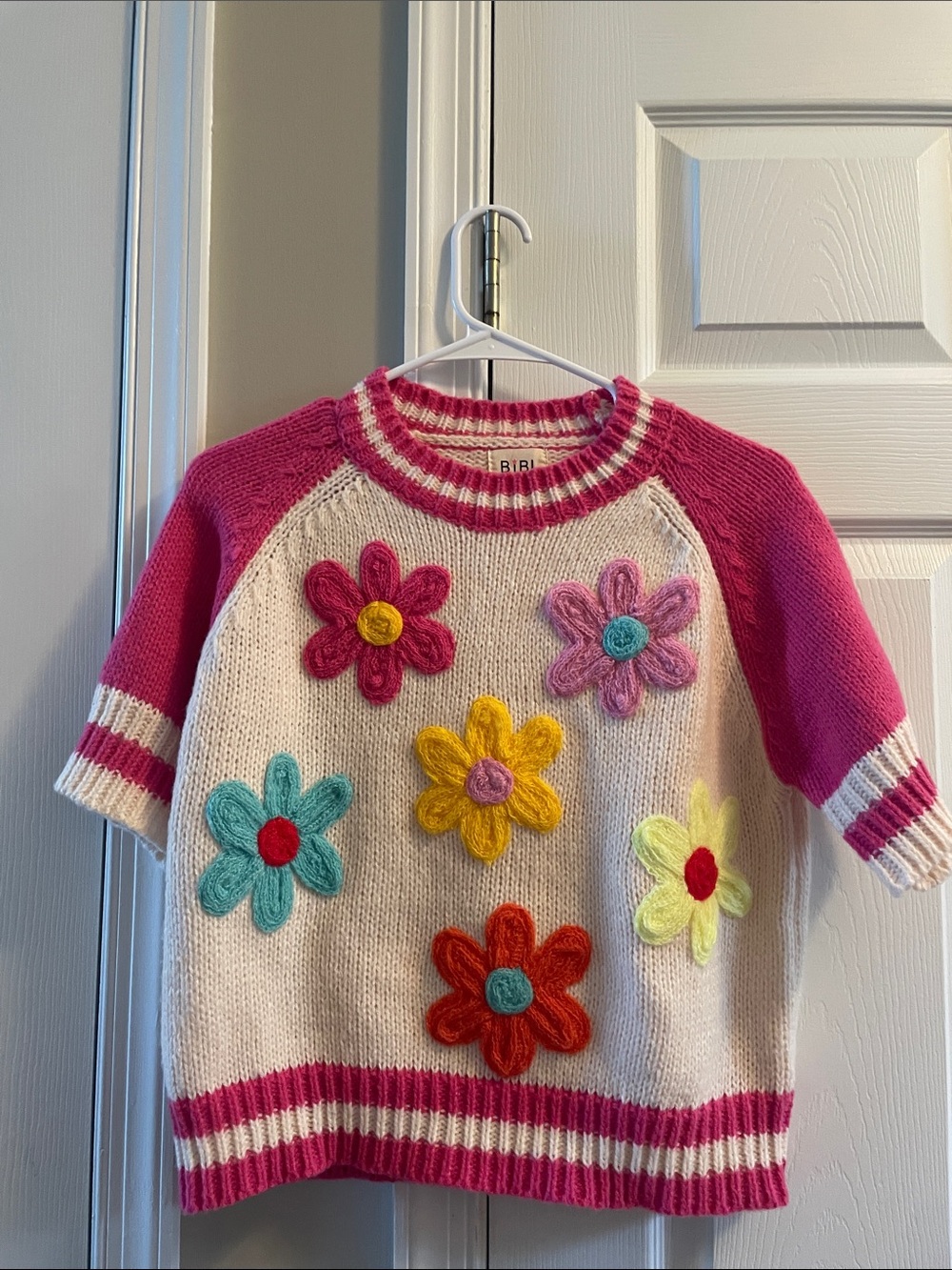 BiBi Cream Crewneck Sweater with Pink Sleeves and Colorful Flower Appliqués